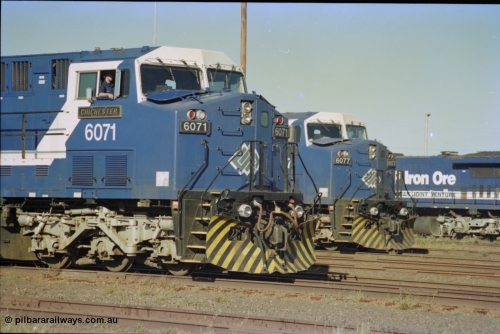 236-31
Nelson Point Loco Overhaul Shop, BHP Iron Ore's General Electric built AC6000 unit 6071 'Chichester' serial 51063 sits out the front with new windscreen protectors or 'blinkers' fitted next to sister unit 6077.
Keywords: 6071;GE;AC6000;51063;