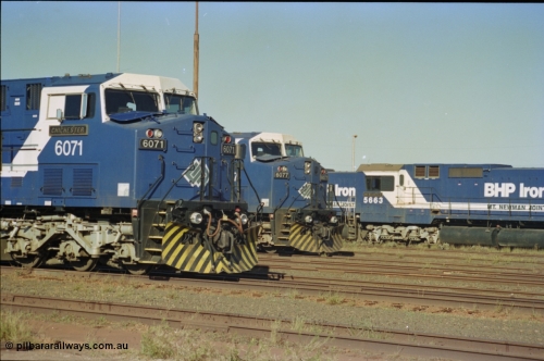 236-32
Nelson Point Loco Overhaul Shop, BHP Iron Ore's General Electric built AC6000 unit 6071 'Chichester' serial 51063 sits out the front with new windscreen protectors or 'blinkers' fitted next to sister unit 6077.
Keywords: 6071;GE;AC6000;51063;