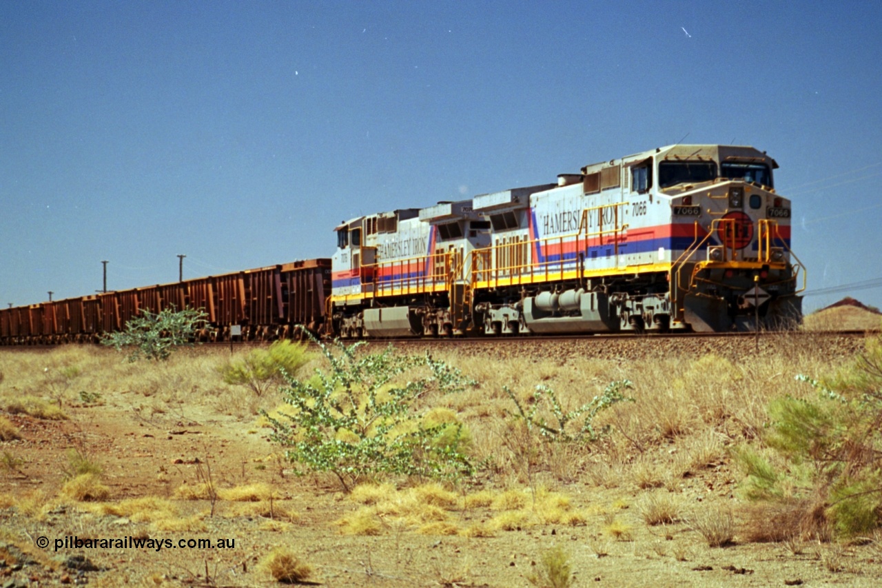 237-35
Dugite Siding, empty train in the passing track behind the standard pair of Hamersley Iron General Electric model Dash 9-44CW units 7066 serial 47745 and 7076 serial 47755. [url=https://goo.gl/maps/6og1H2khBAu] Geodata [/url].
Keywords: 7066;Dash-9-44CW;GE;47745;