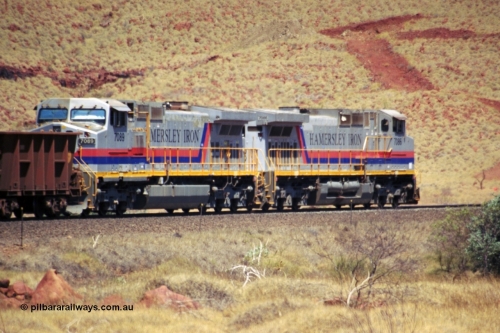 237-32
At the 89 km grade crossing on the Hamersley Iron mainline near Galah Siding, General Electric Dash 9-44CW units 7086 serial 47765 leads 7089 serial 47768 as they struggle up the grade with empty train.
