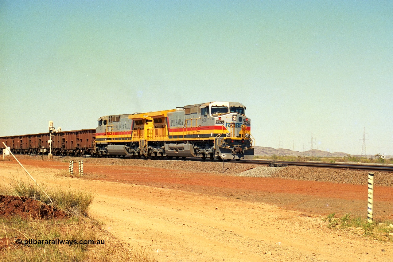 240-26
Seven Mile, loaded train heading for Parker Point behind a pair of Pilbara Rail, Robe River owned, General Electric built Dash 9-44CW units 9470 serial 53455 and 9471 serial 53456. These and sister unit 9472 were the first painted in the Pilbara Rail livery. 31st August 2002.
Keywords: 9470;9471;GE;Dash-9-44CW;53455;53456;