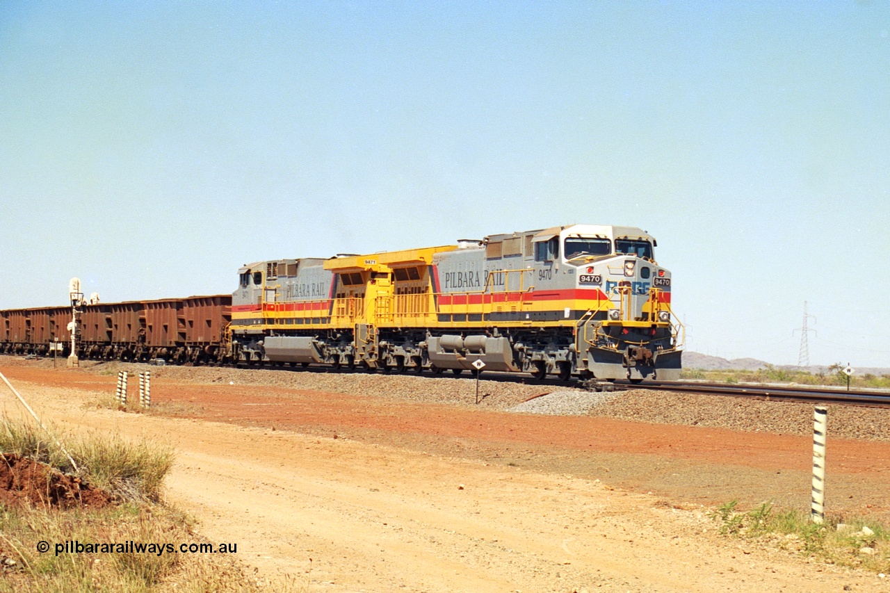 240-27
Seven Mile, loaded train heading for Parker Point behind a pair of Pilbara Rail, Robe River owned, General Electric built Dash 9-44CW units 9470 serial 53455 and 9471 serial 53456. These and sister unit 9472 were the first painted in the Pilbara Rail livery. 31st August 2002.
Keywords: 9470;9471;GE;Dash-9-44CW;53455;53456;