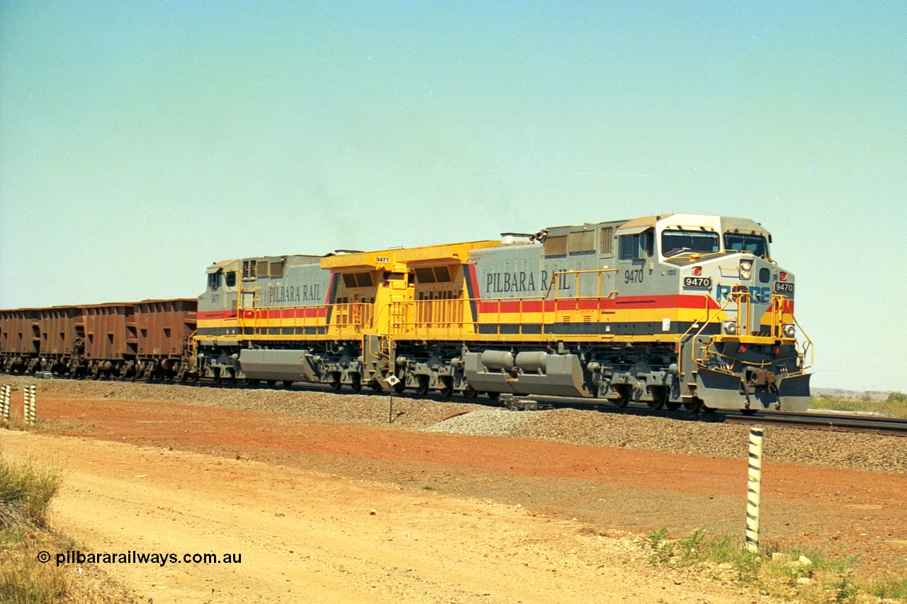 240-28
Seven Mile, loaded train heading for Parker Point behind a pair of Pilbara Rail, Robe River owned, General Electric built Dash 9-44CW units 9470 serial 53455 and 9471 serial 53456. These and sister unit 9472 were the first painted in the Pilbara Rail livery. 31st August 2002.
Keywords: 9470;9471;GE;Dash-9-44CW;53455;53456;