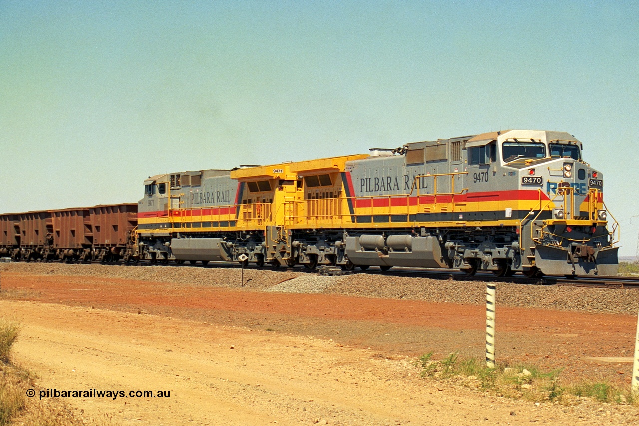 240-29
Seven Mile, loaded train heading for Parker Point behind a pair of Pilbara Rail, Robe River owned, General Electric built Dash 9-44CW units 9470 serial 53455 and 9471 serial 53456. These and sister unit 9472 were the first painted in the Pilbara Rail livery. 31st August 2002.
Keywords: 9470;9471;GE;Dash-9-44CW;53455;53456;