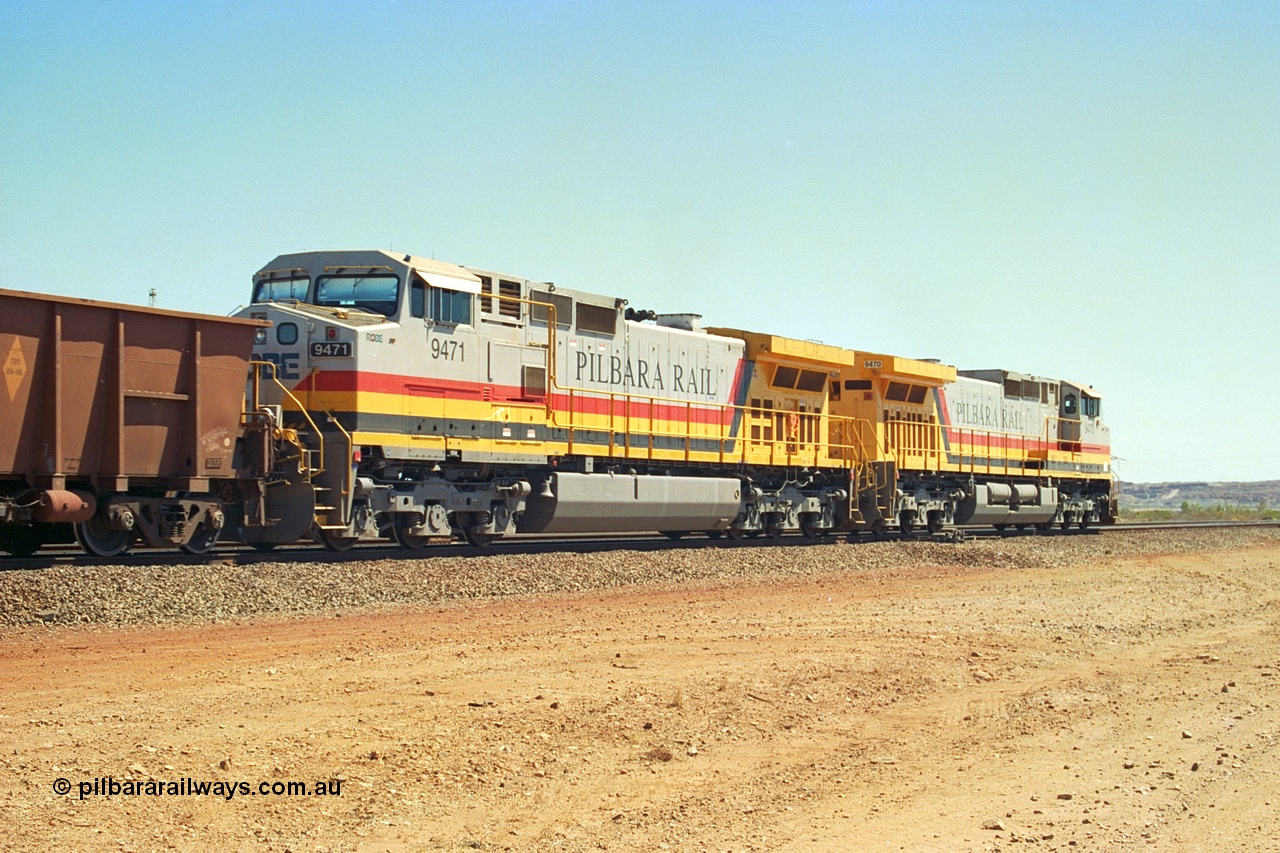 240-34
Seven Mile, trailing view of a loaded train heading for Parker Point behind a pair of Pilbara Rail, Robe River owned, General Electric built Dash 9-44CW units 9470 serial 53455 and 9471 serial 53456. These and sister unit 9472 were the first painted in the Pilbara Rail livery. 31st August 2002.
Keywords: 9470;9471;GE;Dash-9-44CW;53455;53456