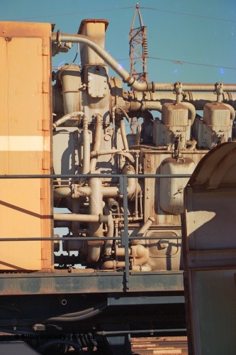 240-06
Nelson Point, retired Mt Newman Mining Comeng NSW built ALCo M636 unit 5499 serial C6096-4 sits with the hood removed exposing the ALCo 251F engine end and turbo charger arrangement. 25th June 2002.
Keywords: 5499;Comeng-NSW;MLW-ALCo;M636;C6096-4;251F;