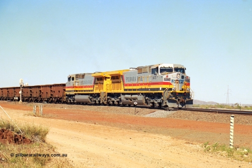 240-27
Seven Mile, loaded train heading for Parker Point behind a pair of Pilbara Rail, Robe River owned, General Electric built Dash 9-44CW units 9470 serial 53455 and 9471 serial 53456. These and sister unit 9472 were the first painted in the Pilbara Rail livery. 31st August 2002.
Keywords: 9470;9471;GE;Dash-9-44CW;53455;53456;