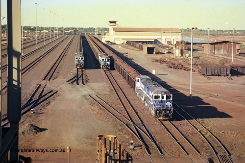 241-28
Nelson Point, Car Dumper 2 holding roads with Yard Control tower and Ore Car Repair Shop in the background as three loaded ore rakes behind a pair of CM40-8M units on each wait their turn through the dumper to discharge. June 2002.
