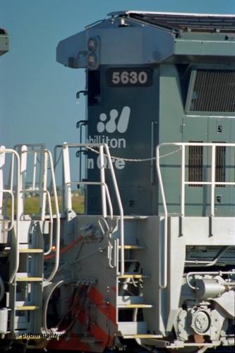 243-32
Nelson Point departure yard, no. 2 end view of BHP Billiton's CM39-8 unit 5630 'Zeus' serial 5831-09 / 88-079 and built new by Goninan WA in the new 'earth' or 'bubble' livery as it trails an empty train waiting departure time. August 2003.
Keywords: 5630;Goninan;GE;CM39-8;5831-09/88-079;