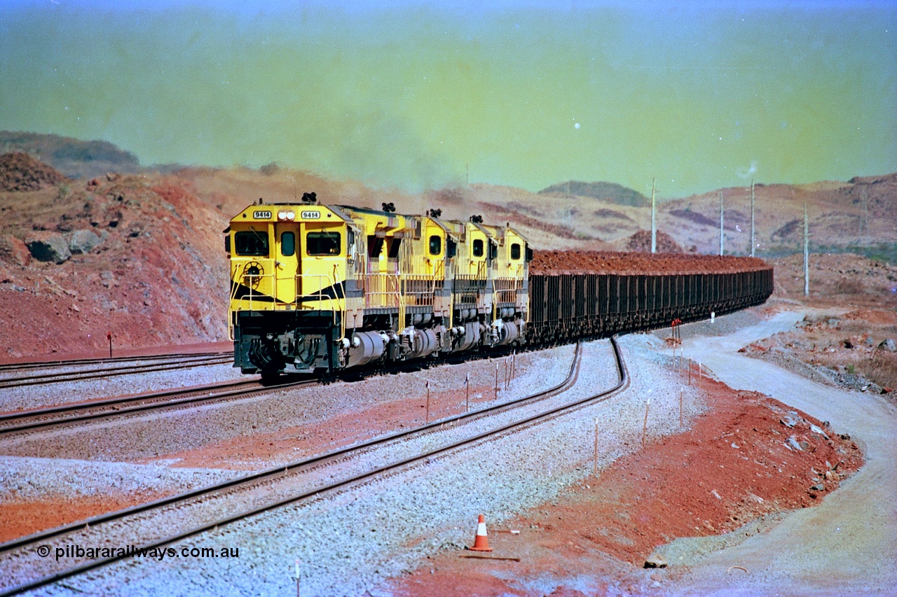 246-16
Cape Lambert, yard view of the then new extension to the south for the West Angelas mine was coming on stream as a Robe River loaded Deepdale train arrives on the main behind the standard quad Dash 8 power with 202 waggons. 9414 which is a Goninan WA ALCo to GE rebuild CM40-8M with serial 8206-11 / 91-124 from November 1991 and was originally an AE Goodwin built M636 ALCo built new for Robe in December 1971 and numbered 262.005, later numbered 1714. 22nd May 2002.
Keywords: 9414;Goninan;GE;CM40-8M;8206-11/91-124;rebuild;AE-Goodwin;ALCo;M636;G6060-5;