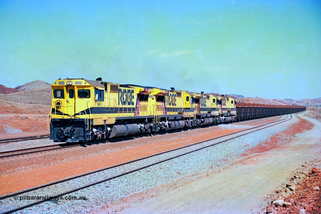246-19
Cape Lambert, a Robe River loaded Deepdale train arrives on the main behind the standard quad Dash 8 power with 202 waggons. 9414 which is a Goninan WA ALCo to GE rebuild CM40-8M with serial 8206-11 / 91-124 from November 1991 riding on Dofasco bogies and was originally an AE Goodwin built M636 ALCo built new for Robe in December 1971 and numbered 262.005, later numbered 1714. 22nd May 2002.
Keywords: 9414;Goninan;GE;CM40-8M;8206-11/91-124;rebuild;AE-Goodwin;ALCo;M636;G6060-5;