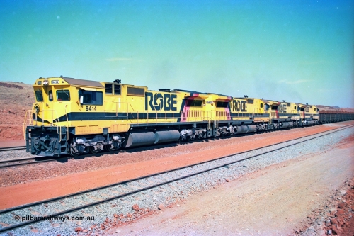 246-21
Cape Lambert, a Robe River loaded Deepdale train arrives on the main behind the standard quad Dash 8 power with 202 waggons. 9414 which is a Goninan WA ALCo to GE rebuild CM40-8M with serial 8206-11 / 91-124 from November 1991 riding on Dofasco bogies and was originally an AE Goodwin built M636 ALCo built new for Robe in December 1971 and numbered 262.005, later numbered 1714. 22nd May 2002.
Keywords: 9414;Goninan;GE;CM40-8M;8206-11/91-124;rebuild;AE-Goodwin;ALCo;M636;G6060-5;