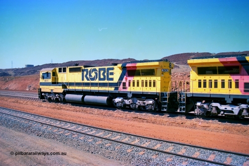 246-22
Cape Lambert, Robe River locomotive 9414 which is a Goninan WA ALCo to GE rebuild CM40-8M with serial 8206-11 / 91-124 from November 1991 riding on Dofasco bogies and was originally an AE Goodwin built M636 ALCo built new for Robe in December 1971 and numbered 262.005, later numbered 1714. Everything below the frame is ALCo while above is GE and Pilbara Cab. 22nd May 2002.
Keywords: 9414;Goninan;GE;CM40-8M;8206-11/91-124;rebuild;AE-Goodwin;ALCo;M636;G6060-5;