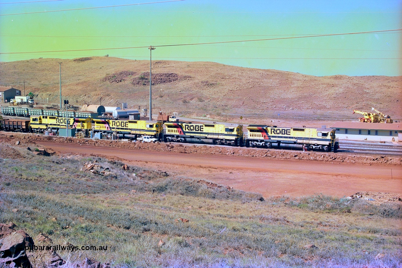 247-17
Cape Lambert overview of the fuel point, with a brace of four CM40-8M rebuilds finishing up refuelling before departing with another empty train. The workshops are to the left of the picture. Where I'm standing to take the picture is now all stockpile. Approximate location of photo is [url=https://goo.gl/maps/B9F4estGGPbd2GrB6]here[/url]. 22nd May 2002.
Keywords: 9425;Goninan;GE;CM40-8M;6266-8/89-85;rebuild;AE-Goodwin;ALCo;M636;G-6041-4;