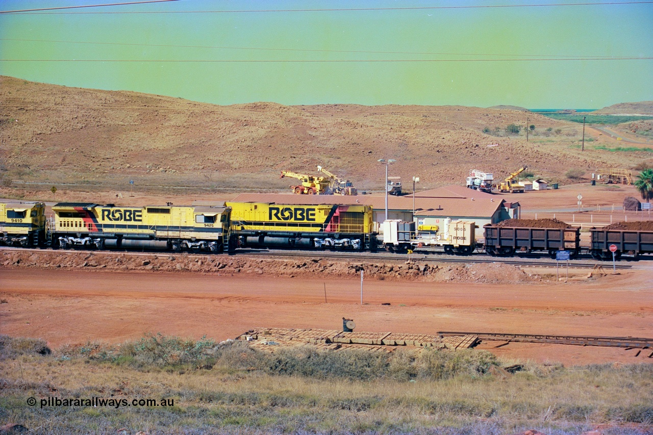 247-22
Cape Lambert yard view with Robe River Comeng WA ALCo Schenectady NY model rebuild C636R unit 9426 dragging a loaded 101 waggon rake from the South Yard across Bells Crossing while a brace of four Goninan CM40-8M GE rebuilds wait at the fuel point for a departure with an empty train. Approximate location of photo is [url=https://goo.gl/maps/TvJoLDjReJ2xoob69]here[/url]. 22nd May 2002.
Keywords: 9426;Comeng-WA;C636R;WA143-1;rebuild;ALCo;Schenectady-NY;C636;Conrail;6782;3499-3;