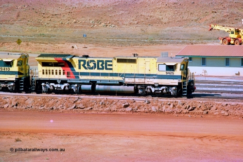 247-05
Cape Lambert fuel point, Robe River Dash 8 power 9425 which is a Goninan WA ALCo to GE rebuild CM40-8M with serial 6266-8 / 89-85 from August 1989 riding on Hi-Ad bogies and was originally an AE Goodwin built M636 ALCo serial C-6041-4 and built new for Mt Newman Mining (later BHP Iron Ore) in April 1970 and numbered 5468, sold to Robe and delivered by road 17th August 1982. Everything below the frame is ALCo while above is GE and Pilbara Cab. Approximate location of the locos is [url=https://goo.gl/maps/DEynwwkV9PZra5Gm7]here[/url]. 22nd May 2002.
Keywords: 9425;Goninan;GE;CM40-8M;6266-8/89-85;rebuild;AE-Goodwin;ALCo;M636;G-6041-4;