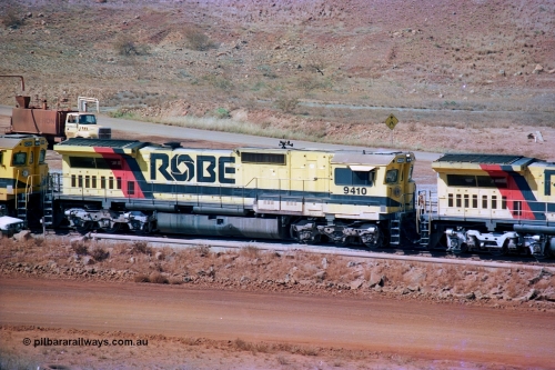 247-06
Cape Lambert fuel point, Robe River locomotive 9410 which is a Goninan WA ALCo to GE rebuild CM40-8M with serial 2160-03 / 96-202 from March 1996 riding on Dofasco bogies and was originally a Comeng NSW built M636 ALCo serial C-6096-5 and built new for Mt Newman Mining (later BHP Iron Ore) in November 1975 and numbered 5500. Everything below the frame is ALCo, with the Comeng build style flat fuel tank, while above is GE and Pilbara Cab. Approximate location of the locos is [url=https://goo.gl/maps/DEynwwkV9PZra5Gm7]here[/url]. 22nd May 2002.
Keywords: 9410;Goninan;GE;CM40-8M;2160-03/96-202;rebuild;Comeng-NSW;ALCo;M636;C-6096-5;