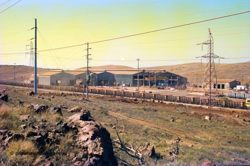 247-14
Cape Lambert overview of the railway workshops buildings and service shops for surface mining equipment. Approximate location of photo is [url=https://goo.gl/maps/B9F4estGGPbd2GrB6]here[/url]. 22nd May 2002.
