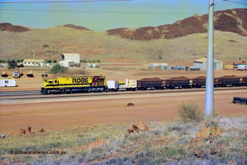 247-16
Cape Lambert, Robe River's 9426 a Comeng WA rebuild from ALCo Schenectady NY model C636 serial 3499-3 originally built in January 1968 for Pennsylvania as #6332, Penn Central 6332 and finally Conrail 6782. Purchased in 1986 and rebuilt by Comeng WA into C636R before delivery to Robe in November 1986. This loco also went on to become DR 8401 for construction of FMG's railway in 2007-08. Seen here dragging a loaded 101 waggon rake down to the car dumper. 22nd May 2002.
Keywords: 9426;Comeng-WA;C636R;WA143-1;rebuild;ALCo;Schenectady-NY;C636;Conrail;6782;3499-3;