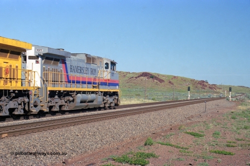 248-12
Dingo Siding on the Hamersley Iron railway at the 39 km with an empty train headed up by a pair of General Electric built Dash 9-44CW units 7077 serial 47756 from the original first order in the Pepsi Can livery and 9408 serial 54158 from the fourth order in the Pilbara Rail livery with Robe ownership markings powers away to the south with the signal marker boards are in the distance. Approximate [url=https://goo.gl/maps/Jv752bD5KXv28oUV7]location[/url]. 24th April 2004.
Keywords: 7077;GE;Dash-9-44CW;47756;