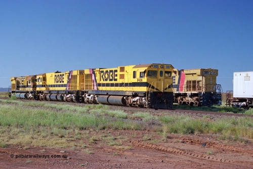 248-15
Seven Mile yard, stored Robe River ALCo locomotives at the south end of the Hamersley Iron Seven Mile yard on roads N2 and N3. On road N2 is 9426 a Comeng WA C636R rebuild from ALCo Schenectady NY model C636 serial 3499-3 originally built in January 1968 for Pennsylvania Railroad as #6332, Penn Central 6332 and finally Conrail 6782. Purchased in 1986 and rebuilt by Comeng WA into C636R before delivery to Robe in November 1986. This loco also went on to become DR 8401 for construction of FMG's railway in 2007-08. Behind it is sister unit 9427 and ALCo M636 9412. Approximate [url=https://goo.gl/maps/CXwAreRPb2RymQ9m9]location[/url]. 24th April 2004.
Keywords: 9426;Comeng-WA;C636R;WA143-1;rebuild;ALCo;Schenectady-NY;C636;Conrail;6782;3499-3;