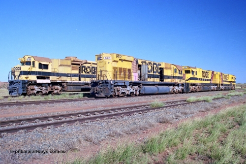 248-20
Seven Mile yard, stored Robe River ALCo locomotives at the south end of the Hamersley Iron Seven Mile yard on roads N2 and N3. On N2 is AE Goodwin built ALCo M636 unit 9412 serial G-6060-3 from December 1971 and originally numbered 262.003 during construction and then 1712 on MLW Dofasco bogies with C636R units 9427 and 9426 on Hi-Ad bogies. Beside it on N3 is 9416 also an AE Goodwin built ALCo M636 serial G-6046-16 from January 1973 and originally numbered 1716 on MLW Dofasco bogies but with a C630 fuel tank in place of the original M636 and larger tank. Approximate [url=https://goo.gl/maps/CXwAreRPb2RymQ9m9]location[/url]. 24th April 2004.
Keywords: 9412;AE-Goodwin;MLW-ALCo;M636;G6060-3;