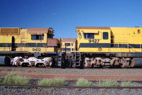 248-21
Seven Mile yard, stored Robe River ALCo locomotives at the south end of the Hamersley Iron Seven Mile yard on roads N2 and N3. On N2 is a cab comparison between AE Goodwin built ALCo M636 unit 9412 serial G-6060-3 from December 1971 and originally numbered 262.003 during construction and then 1712 on MLW Dofasco bogies with C636R units 9427 a Comeng WA C636R rebuild from ALCo Schenectady NY model C636 serial 3499-2 originally built in January 1968 for Pennsylvania Railroad as #6331, Penn Central 6331 and finally Conrail 6781. Purchased in 1986 and rebuilt by Comeng WA into C636R before delivery to Robe in January 1987 riding on the ALCo Hi-Ad bogie. This loco also went on to become DR 8403 for construction of FMG's railway in 2007-08. Behind it on N3 is 9413. Approximate [url=https://goo.gl/maps/CXwAreRPb2RymQ9m9]location[/url]. 24th April 2004.
Keywords: 9412;AE-Goodwin;MLW-ALCo;M636;G6060-3;