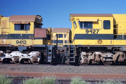248-22
Seven Mile yard, stored Robe River ALCo locomotives at the south end of the Hamersley Iron Seven Mile yard on roads N2 and N3. On N2 is a cab comparison between AE Goodwin built ALCo M636 unit 9412 serial G-6060-3 from December 1971 and originally numbered 262.003 during construction and then 1712 on MLW Dofasco bogies with C636R units 9427 a Comeng WA C636R rebuild from ALCo Schenectady NY model C636 serial 3499-2 originally built in January 1968 for Pennsylvania Railroad as #6331, Penn Central 6331 and finally Conrail 6781. Purchased in 1986 and rebuilt by Comeng WA into C636R before delivery to Robe in January 1987 riding on the ALCo Hi-Ad bogie. This loco also went on to become DR 8403 for construction of FMG's railway in 2007-08. Behind it on N3 is 9413. Approximate [url=https://goo.gl/maps/CXwAreRPb2RymQ9m9]location[/url]. 24th April 2004.
Keywords: 9412;AE-Goodwin;MLW-ALCo;M636;G6060-3;