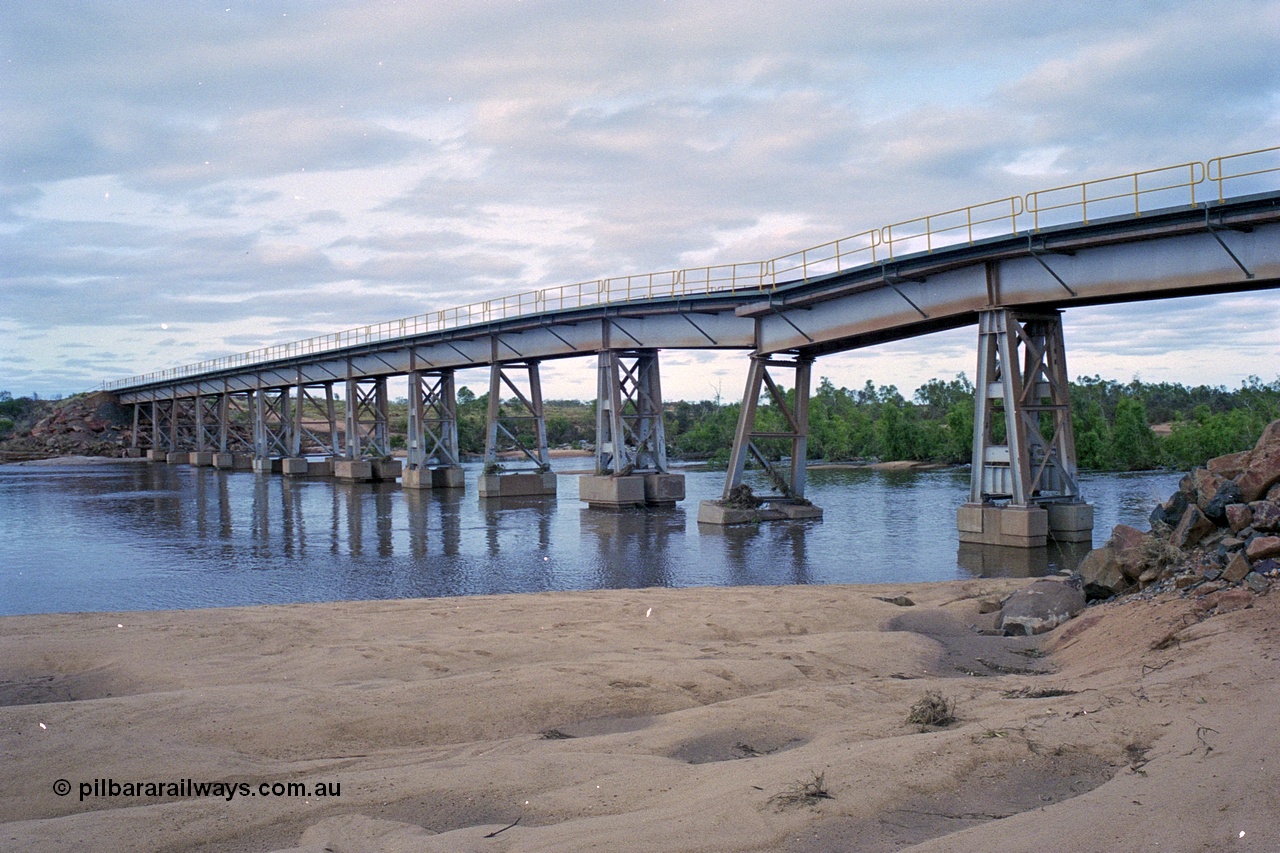 249-07
Yule River bridge looking north east upstream the third pier from the southern end was undermined by flood waters from Tropical Cyclone John in December 1999. The rail line was closed for two weeks while repairs were effected. Approximate [url=https://goo.gl/maps/phCWr8u1xnuBdzwj6]location[/url].
