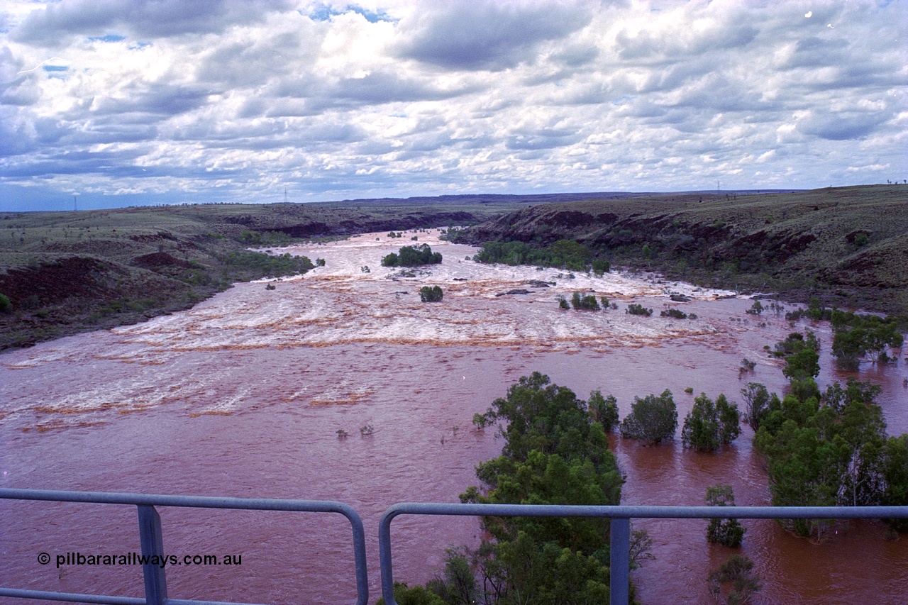 249-24
Fortescue River Bridge on the Robe River line at the 115.8 km in flood looking downstream to the west from the middle of the bridge following Cyclone John on 18th December 1999. Approximate [url=https://goo.gl/maps/x9Cwp468FXgohtvK8]location[/url].
