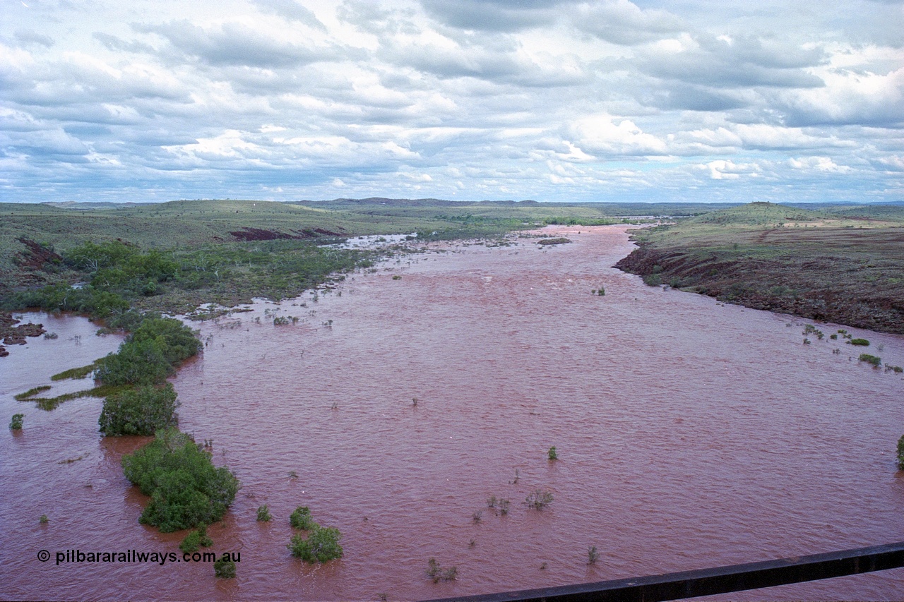 249-25
Fortescue River Bridge on the Robe River line at the 115.8 km in flood looking upstream to the east from the middle of the bridge following Cyclone John on 18th December 1999. Approximate [url=https://goo.gl/maps/x9Cwp468FXgohtvK8]location[/url].
