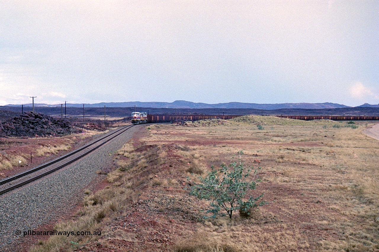 249-27
A loaded Hamersley Iron train runs across the plains north of Dingo Siding near the 70 km as it nears the destination of its cargo. Approximate [url=https://goo.gl/maps/UUfj15vTkvBaPCaw8]location[/url]. 18th December 1999.
