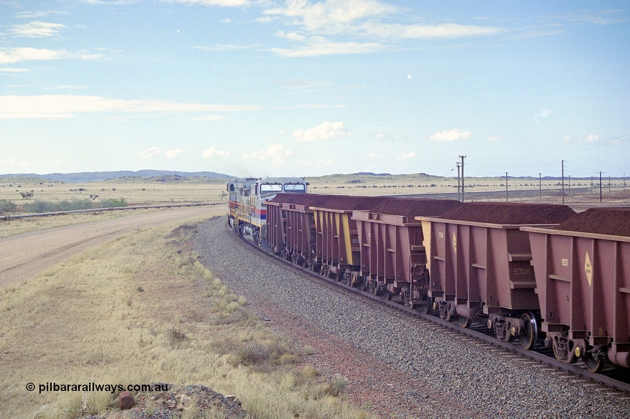 249-32
A loaded Hamersley Iron train runs across the plains north of Dugite Siding near the 70 km as it nears the destination of its cargo behind the standard pair of GE built Dash 9-44CW locomotives 7084 serial 47763 and 7079 serial 47758 both in the original Pepsi Can livery. Approximate [url=https://goo.gl/maps/UUfj15vTkvBaPCaw8]location[/url]. 18th December 1999.
Keywords: 7079;GE;Dash-9-44CW;47758;M-series;
