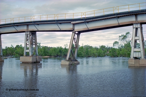 249-06
Yule River bridge looking east upstream the third pier from the southern end was undermined by flood waters from Tropical Cyclone John in December 1999. The rail line was closed for two weeks while repairs were effected. Approximate [url=https://goo.gl/maps/phCWr8u1xnuBdzwj6]location[/url].
