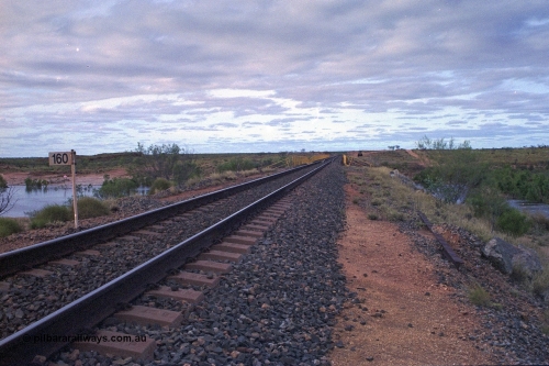 249-14
Yule River bridge looking north from the 160 km on the BHP mainline. The third pier from the southern end was undermined by flood waters from Tropical Cyclone John in December 1999. The rail line was closed for two weeks while repairs were effected. Approximate [url=https://goo.gl/maps/phCWr8u1xnuBdzwj6]location[/url].
