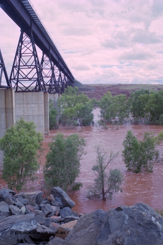 249-21
Fortescue River Bridge on the Robe River line at the 115.8 km in flood looking south following Cyclone John on 18th December 1999. Approximate [url=https://goo.gl/maps/CDTmtMLJewGrMq699]location[/url].
