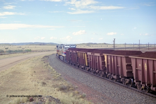 249-32
A loaded Hamersley Iron train runs across the plains north of Dugite Siding near the 70 km as it nears the destination of its cargo behind the standard pair of GE built Dash 9-44CW locomotives 7084 serial 47763 and 7079 serial 47758 both in the original Pepsi Can livery. Approximate [url=https://goo.gl/maps/UUfj15vTkvBaPCaw8]location[/url]. 18th December 1999.
Keywords: 7079;GE;Dash-9-44CW;47758;M-series;