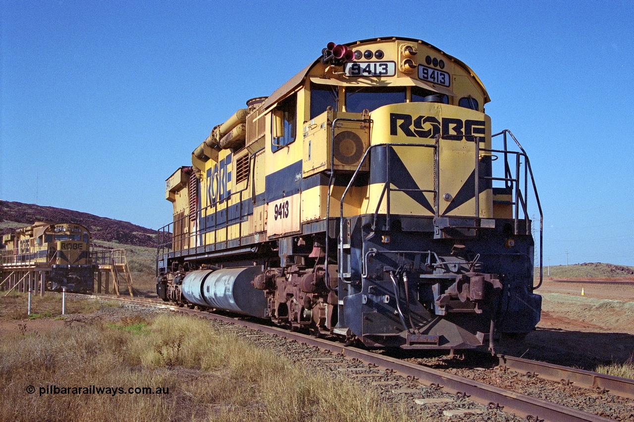 250-20
Cape Lambert yard on the Load Box Spur is recently stored Robe River AE Goodwin built ALCo M636 unit 9413 serial G6060-4 from December 1971, originally numbered 262.004 during construction, renumbered to 86-14-1713 with number boards 1713 and finally 9413. The ducting on the hood is the air to air intercooler modifications. 22nd October 2000.
Keywords: 9413;AE-Goodwin;ALCo;M636;G6060-4;
