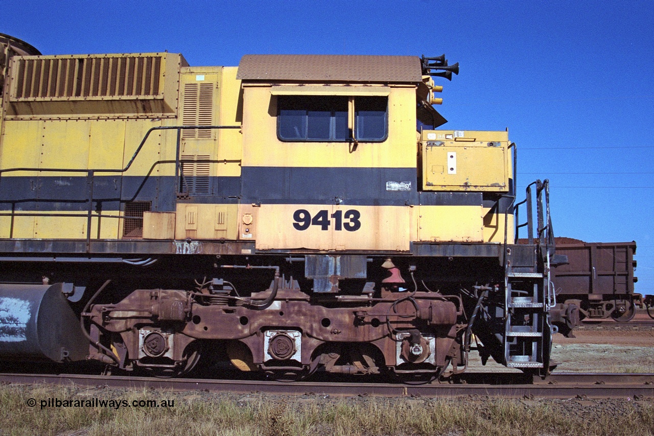 250-27
Cape Lambert yard on the Load Box Spur is recently stored Robe River AE Goodwin built ALCo M636 unit 9413 serial G6060-4 from December 1971, originally numbered 262.004 during construction, renumbered to 86-14-1713 with number boards 1713 and finally 9413. The ducting on the hood is the air to air intercooler modifications. 22nd October 2000.
Keywords: 9413;AE-Goodwin;ALCo;M636;G6060-4;