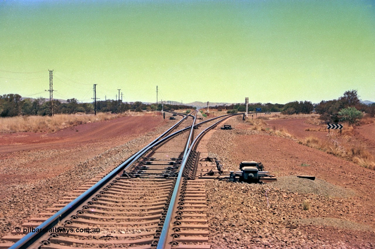 252-16
Rosella Junction looking south at the 251 km. The line to the left goes to Marandoo and Yandicoogina, the straight to Tom Price and Paraburdoo and the right heads to Brockman. Location is roughly [url=https://goo.gl/maps/q3opSy2bPxpd8nv79]here[/url]. 24th November 2001.

