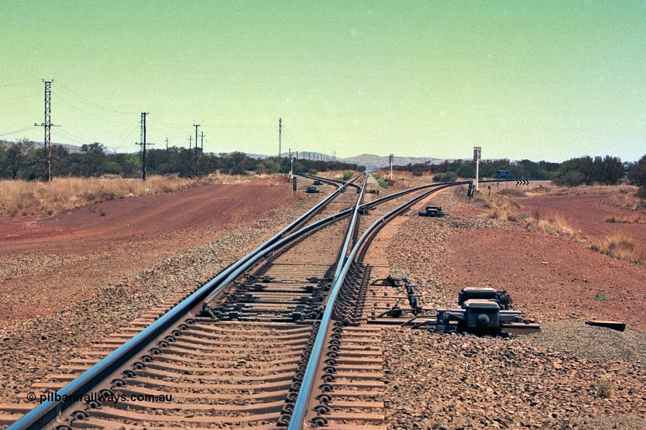 252-17
Rosella Junction looking south at the 251 km. The line to the left goes to Marandoo and Yandicoogina, the straight to Tom Price and Paraburdoo and the right heads to Brockman. Location is roughly [url=https://goo.gl/maps/q3opSy2bPxpd8nv79]here[/url]. 24th November 2001.
