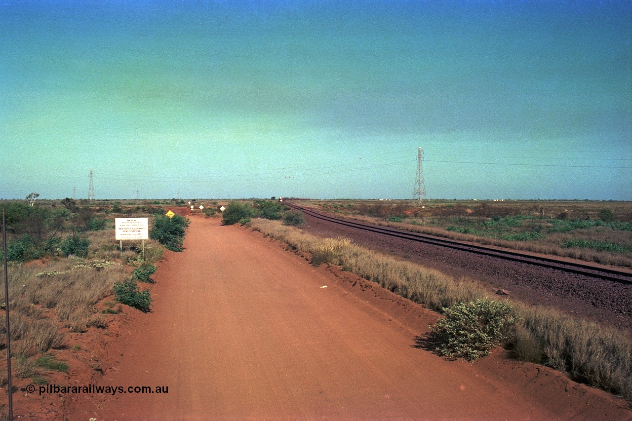 252-29
Port Hedland at 12 Mile Creek a loaded Yarrie train in the distance approaches the creek, the landscape west of Port Hedland is rather flat! Early December 2001.
