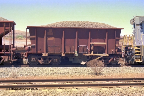 252-11
Cockatoo Siding 273 km on the Hamersley Iron line to Yandi, ballast plough waggon BP 02 is on the end of a ballast rake being loaded. BP 01 has been converted from an Nippon Sharyo ore waggon with the fitting of a plough blade, the waggon is also loaded with ballast for ballast. Location is roughly [url=https://goo.gl/maps/gNdgoAj6uJoYb2q36]here[/url]. 24th November 2001.
Keywords: BP-type;BP01;Rio-ballast-plough;Nippon-Sharyo;