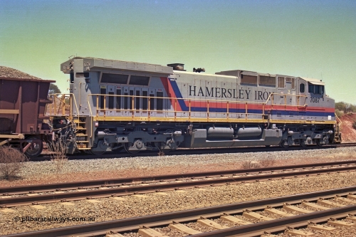 252-12
Cockatoo Siding 273 km on the Hamersley Iron line to Yandi, General Electric built 9-44CW unit 7087 with serial number 47766 from the original 1994 build idles away on the western end of the ballast train as it is loaded and slowly progresses into the back track siding Ballast plough BP 01 is behind the locomotive. Location is roughly [url=https://goo.gl/maps/rNdCHRcDhbQuHTjd7]here[/url]. 24th November 2001.
Keywords: 7087;GE;Dash-9-44CW;47766;