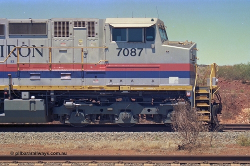 252-13
Cockatoo Siding 273 km on the Hamersley Iron line to Yandi, General Electric built 9-44CW unit 7087 with serial number 47766 from the original 1994 build idles away on the western end of the ballast train. Cab side view. Location is roughly [url=https://goo.gl/maps/rNdCHRcDhbQuHTjd7]here[/url]. 24th November 2001.
Keywords: 7087;GE;Dash-9-44CW;47766;