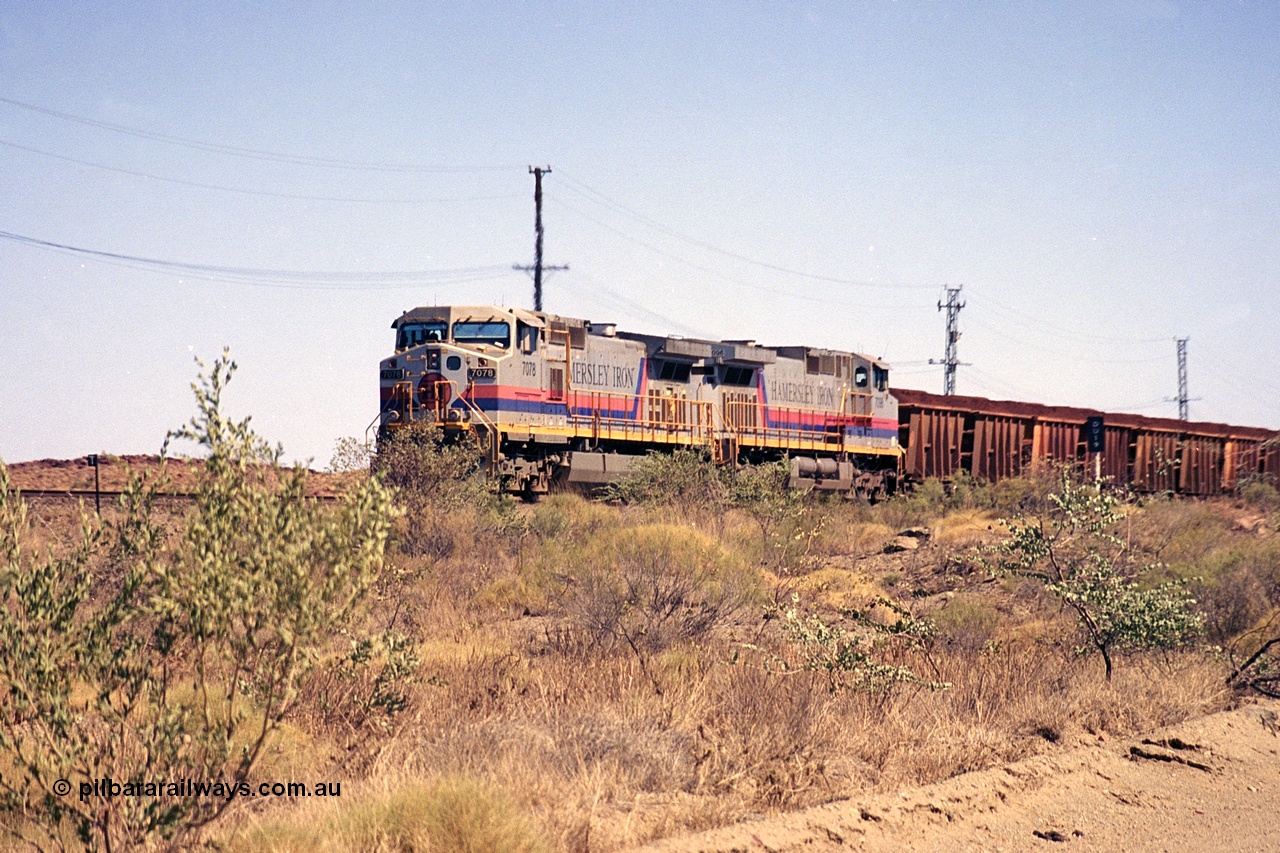 253-02
Dugite near the 64 km on the Dampier - Tom Price railway, a loaded Hamersley Iron train headed up by General Electric 9-44CW units 7078, from the original order, serial number 47757 and 7096, from the second order, serial number 52843 arrive taking the mainline to cross an empty which is in the passing track.
Keywords: 7078;GE;Dash-9-44CW;47757;