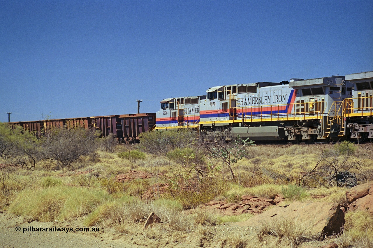 253-05
Dugite near the 64 km on the Dampier - Tom Price railway, a loaded Hamersley Iron train headed up by General Electric 9-44CW unit 7078, from the original order with serial number 47757 roll past an empty train on the passing track with second unit 7076.
Keywords: 7078;GE;Dash-9-44CW;47757;