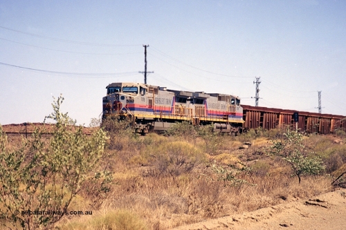 253-02
Dugite near the 64 km on the Dampier - Tom Price railway, a loaded Hamersley Iron train headed up by General Electric 9-44CW units 7078, from the original order, serial number 47757 and 7096, from the second order, serial number 52843 arrive taking the mainline to cross an empty which is in the passing track.
Keywords: 7078;GE;Dash-9-44CW;47757;