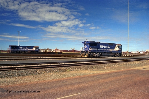 253-32
Nelson Point yard sees BHP dumper pilot locomotives 5666 'Taranto', a Goninan GE rebuild CM40-8MEFI model with serial 8412-11 / 94-157, 5666 was the first unit fitted with Electronic Fuel Injection to the 16FDL engine hence the EFI on the model designation, and in the background with compressor set No. 2 is 5633 which was a new build CM39-8 GE model by Goninan. A sharp eye will notice the difference in the fuel tanks of the two locomotives.
Keywords: 5666;Goninan;GE;CM40-8MEFI;8412-11/94-157;rebuild;Comeng-NSW;ALCo;M636C;5487;C6084-3;