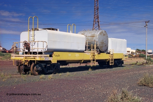 253-34
Nelson Point hard stand area, riveted flat waggon 202 with three water tanks fitted, view of handbrake end, originally part of the 'camp train', modified by Mt Newman Mining railway workshops.
Keywords: BHP-flat-waggon;